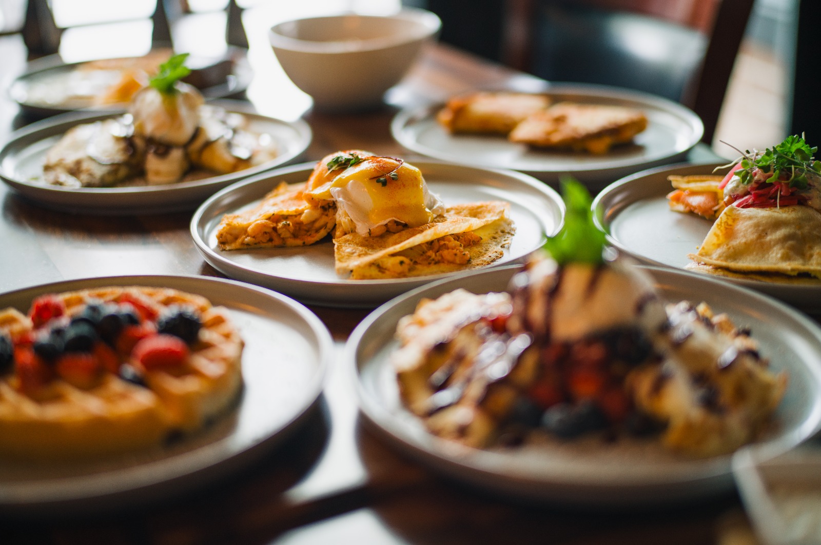 Weekend brunch spread at Grappa in Queen Anne, Seattle — eggs benedict, berry waffle and crepes