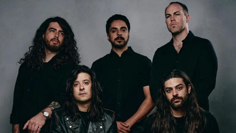 The five members of Hail The Sun in black shirts posing against a grey studio backdrop, ahead of their El Corazon show with A Lot Like Birds near Grappa