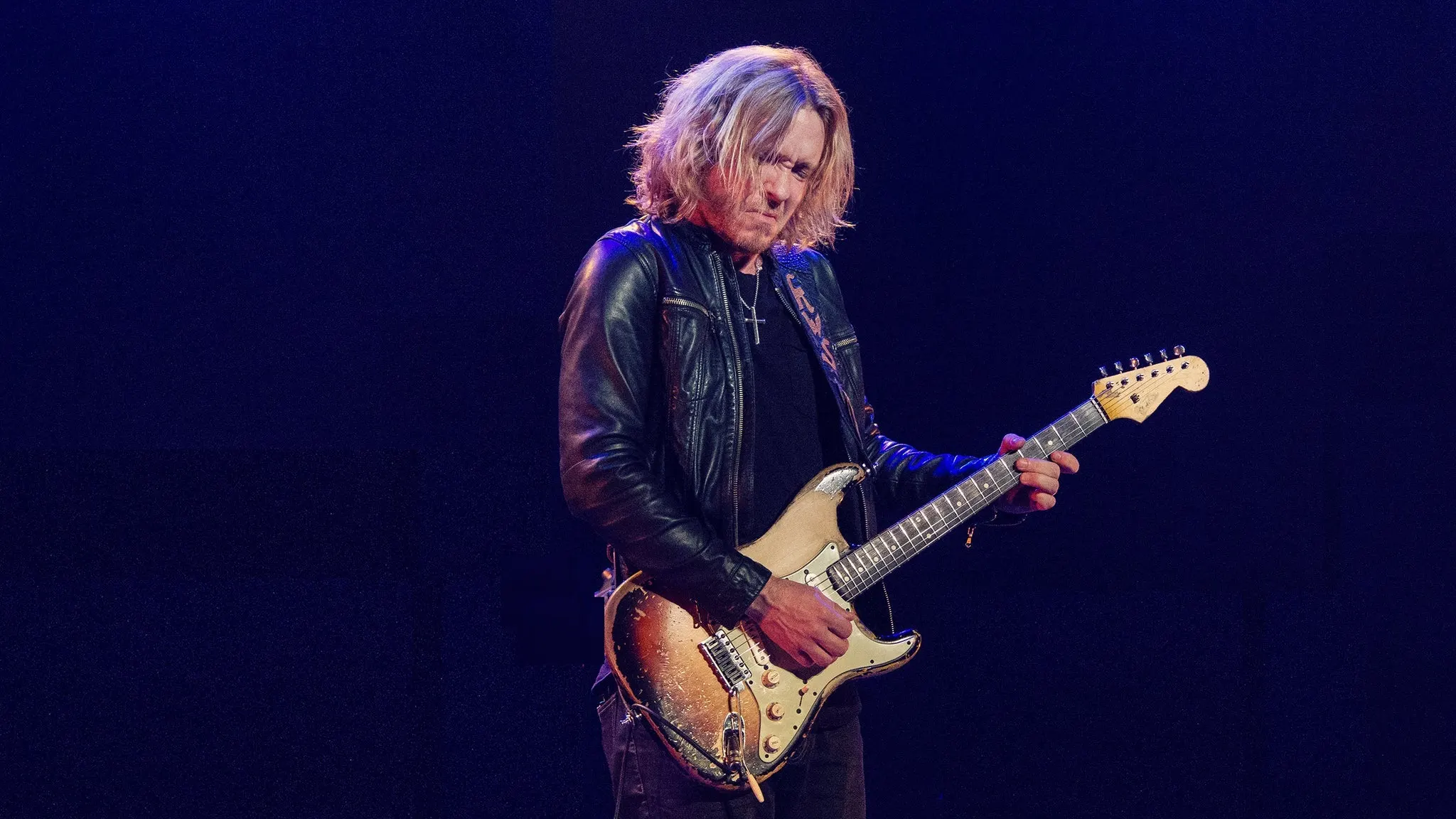 Kenny Wayne Shepherd playing a worn sunburst electric guitar on a dark stage, ahead of his Moore Theatre show a short drive from Grappa in Queen Anne