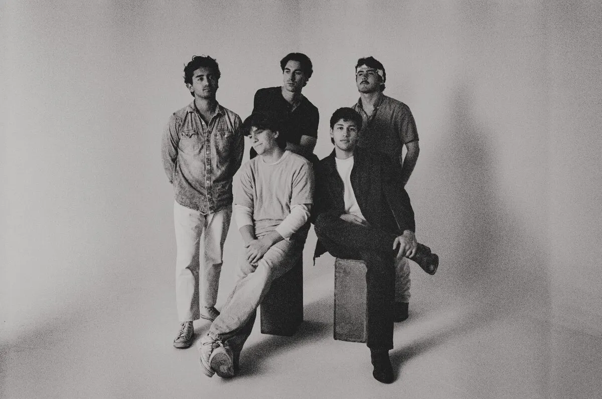 Black and white studio photo of the five members of WEST 22ND, two seated on low blocks and three standing behind them, ahead of their Nectar Lounge show near Grappa